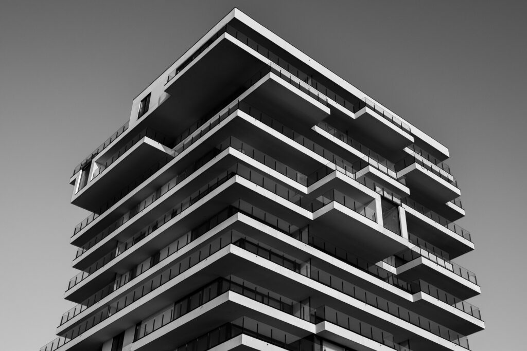 A striking black and white photo of a modern high-rise building with unique geometric designs.