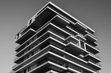 A striking black and white photo of a modern high-rise building with unique geometric designs.